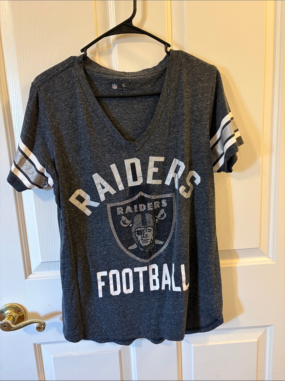 Woman’s Raiders V-Neck Tee in Charcoal with White Stripes diamond emblem size Lg